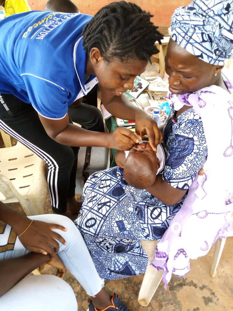 A health worker administers a vaccine to a baby. Photo: Hen Mpoano.