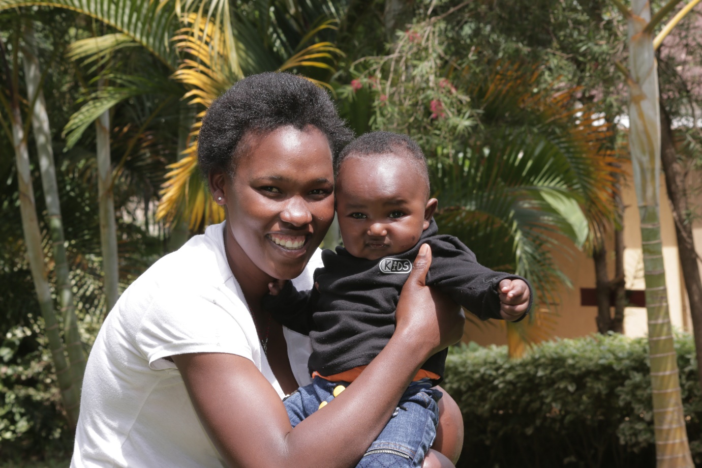 Susan Kerubo, a beneficiary of Tunza Mama services in Kisii, holding her son.